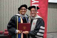 Sherman graduate, Javier A. Canales-Diaz (left), is shown receiving his diploma from Sherman President Dr. Jack Bourla.