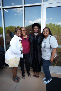 A family celebrating with a Sherman graduation following the commencement event.