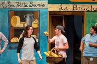 With a marketplace backdrop, characters play a scene in the market during a rehearsal for "Cinderella."