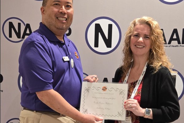 Emil Chuck, editor in chief at the Health Professional Student Association (left) presents the 2026 Undergraduate Advisor of the Year award to Cailín M. Cordon-Waldman (right).