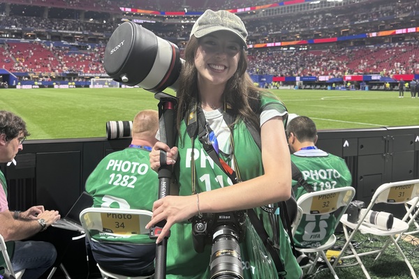 Representation of the achievement named 'Journalism student plying her craft as a World Cup photographer'.