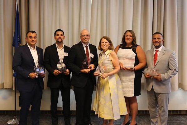From left, are Ali Soufan ’94, Owen Newkam-Ulrich ’21, Mark Serva ’87, Ginny Richards ’75, Bridget Irwin ’07 and Rocco Zegalia ’94.