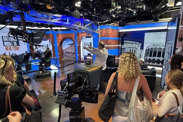 group of students on a television studio set in New York