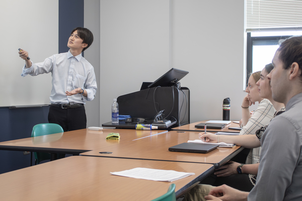 Hideki Arahari, Ph.D., of Basic Research Laboratories at NTT, Inc. in Japan, speaks to Trine University students and faculty in Fawick Hall on Monday, June 29. (Photo by James Tew / Trine University)