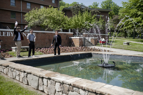 Members of the YHC Spat Club celebrate as the fountain in front of the Appleby Resident Hall springs to life.