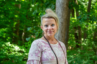 woman standing in front of trees