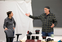 Stephan Savoia gestures while speaking in a photography class at SUNY Potsdam. Professor Iggy Beerbower looks on.