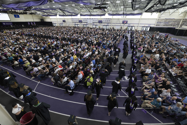 College graduates and their families at a commencement ceremony.