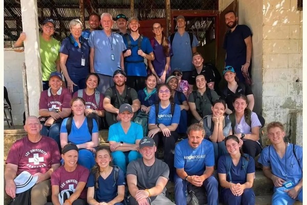 Lee University students, faculty, alumni, and medical professionals pause for a team photo outside the school in El Paraiso, Honduras, where they operated a temporary medical clinic during the university's annual medical mission trip.