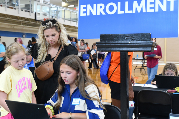 Lindsey Wilson University student Macey Poindexter ’30 of Burkesville, Kentucky, finalizes her registration in the Doris and Bob Holloway Health & Wellness Center during the university’s July 9 New Student Orientation day as her mother, Kristy Flowers Williams ’03, and sister, Londyn, 8, look on. More than 400 students and family members attended Lindsey Wilson’s second New Student Orientation days of the summer on July 9-10.