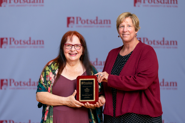 Karen Butler Easter ’75 of Potsdam, N.Y., is the recipient of the 2026 Minerva Award from the SUNY Potsdam Alumni Association. She is seen here accepting the honor from SUNY Potsdam President Dr. Suzanne R. Smith (right) at Reunion 2026.
