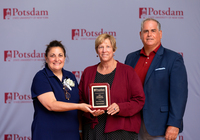 Mia Wicke, Suzanne Smith and John Wicke pose with the Honorary Lifetime Membership Award.