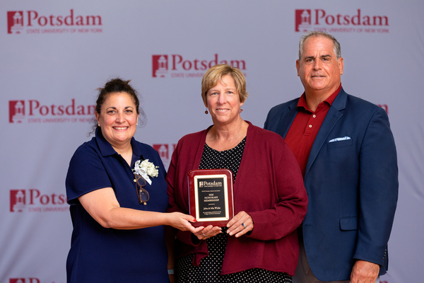 The SUNY Potsdam Alumni Association has named John and Mia Wicke of Massena, N.Y., honorary alumni. The couple is seen here after accepting the award from SUNY Potsdam President Dr. Suzanne Smith (center) at Reunion 2026.