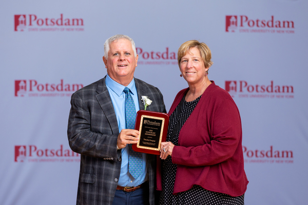 The SUNY Potsdam Alumni Association has named Tim Dempsey of Portsmouth, N.H., an honorary alumnus. He is seen here after accepting the award from SUNY Potsdam President Dr. Suzanne Smith (right) at Reunion 2026.