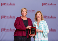 Sally Farrell Partner and Suzanne Smith pose with the Donald L. Tompkins Distinguished Service Award.