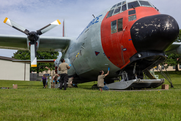 Airmen assigned to the 109th Airlift Wing, based at Stratton Air National Guard Base in Scotia, New York, work together to repaint the gate guardian that sits at the entrance of the base on July 15, 2026.  The LC-130D model originally flew with the Alaskan Air Command before flying with the 109th from 1975-1985.  It was brought back to the base as a static display in 1994. (U.S. Air National Guard photo by Jaclyn Lyons)