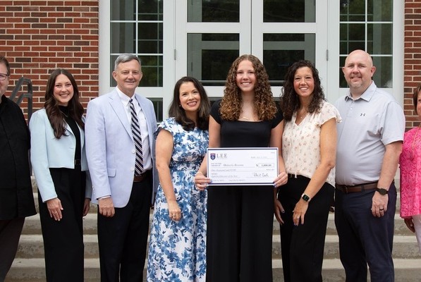 Makayla Broome (center), the inaugural recipient of Lee University's Aspiring Educator of the Year Scholarship, is pictured with her parents and Lee faculty following the scholarship presentation. Pictured from left are Dr. Shane Brown, director of teacher education; Micaleah Parker, director of undergraduate admissions; Dr. Bill Estes, dean of the Helen DeVos College of Education; Rachael Pitts, assistant director of teacher education; Broome; Ashley Broome and Michael Broome, Makayla’s parents; and Angela Kersey, a Teaching as a Profession teacher at Bradley Central High School.