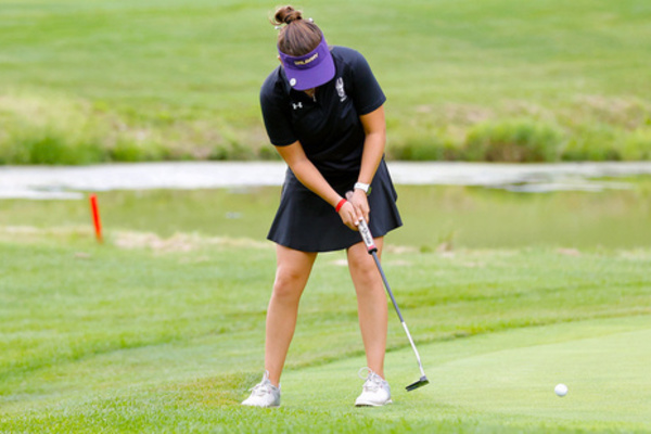 UAlbany Women's Golfer playing on the putting green.