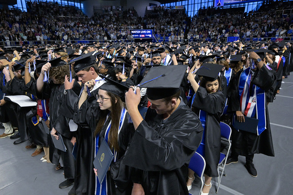 MTSU graduates move their cap tassels from right to left at the conclusion of spring commencement.