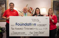 Four people stand behind an oversized check for $200,000 made out to The Foundation at SRTC from Five Star Credit Union.