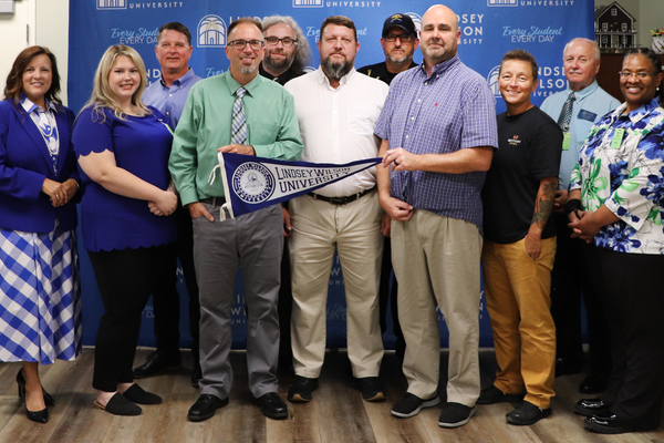 Lindsey Wilson and Red Onion State Prison have launched a partnership to expand educational opportunities to employees at the state institution. The agreement makes the prison’s full-time and part-time employees and their immediate family members eligible to receive scholarship opportunities through Lindsey Wilson. Pictured, front row, from left: LWU Assistant Vice President of Educational Outreach Tommie Saragas; LWU Enrollment Coordinator Leanna Perkins; Lindsey Wilson Director of Enrollment Ryan Vitatoe; Red Onion Warden David Anderson; Red Onion Senior Mental Health Clinician Edward Richie Creech; Red Onion Warden Amee Duncan; and LWU Regional Academic Director Kimberly Brown. Back row, from left: LWU counseling professor Richard Carroll; LWU Enrollment Coordinator Jason Weaver; Red Onion State Major Steve Franklin; and LWU criminal justice professor Dennis Souther.