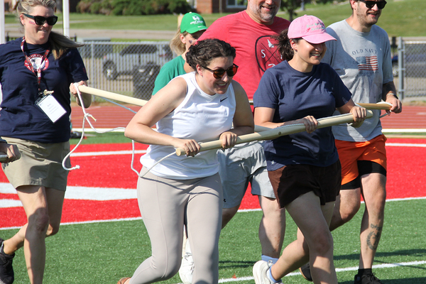 OFF TO THE RACES: A three-person "chariot" race was part of the Olympic competition between the teachers on the next-to-last day of the NEH summer institute.