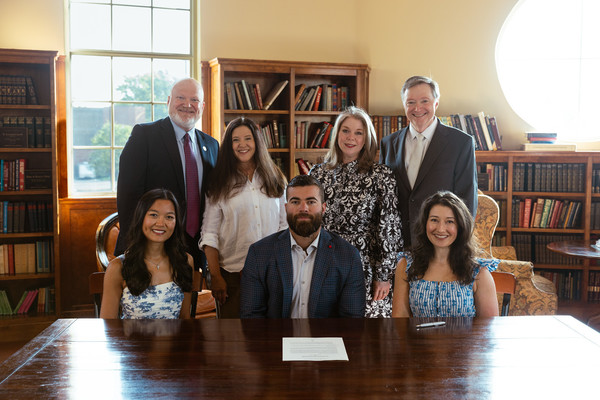 Pictured at the signing ceremony for the Dr. Mark Williams Annual Scholarship are (standing, left to right) Lee University President Dr. Phil Cook, Tonya Cook, Sandra Kay Williams, and Dr. Mark Williams; and (seated, left to right) Grace Tinsley, Matthew Tinsley, and Bailea Tinsley Ogden. 