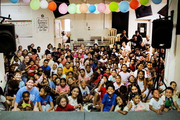 LWU Dominican Republic 01 -- Members of the Lindsey Wilson University mission team are joined by more than 100 children one evening at the Vacation Bible School held at Central Christian Church in Santiago, Dominican Republic. A total of 20 Lindsey Wilson students, faculty, staff and alumni spent a week on a mission trip to the Dominican Republic. It was the 14th time the university has sent members on the trip.