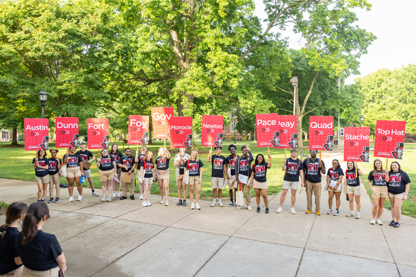 Orientation Leaders hold their signs in the Browning Quadrangle
