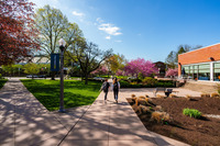 Two students walk alongside the Mund College Center