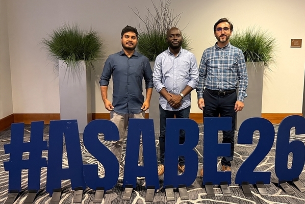 Students pose in front of #ASABE26 signage