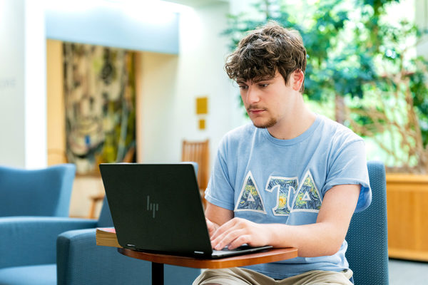 Ethan Ross works on a laptop.