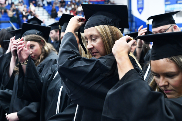 Lindsey Wilson University undergraduates move the tassel on their mortarboard from right to left to signify their graduation at the university’s inaugural summer commencement ceremony. Lindsey Wilson awarded 292 degrees at its 124th commencement ceremony, held Saturday, Aug. 15, in Biggers Sports Center.