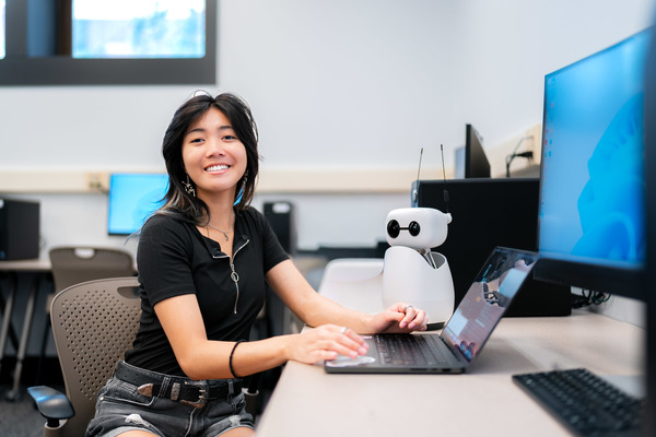 Melina Sarion with robot and computers at Muhlenberg College
