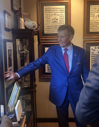 NEMCC President Dr. Ricky G. Ford examines a framed item among the photographs and memorabilia displayed in the heritage room.