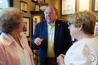 Former Mississippi Rep. Steve Holland gestures while speaking with two guests inside the William “Billy” McCoy Mississippi Heritage Room.