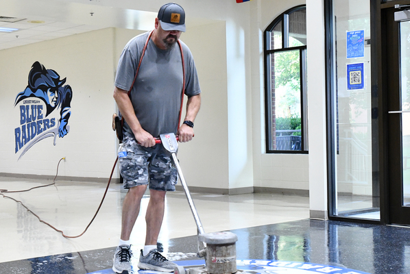 Lindsey Wilson University Plant Operations staff member Darin Taylor waxes the floor of the Cralle Student Union Building in late July. Lindsey Wilson’s Welcome Week will be Aug. 21-28. Fall classes begin Monday, Aug. 24.