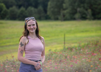 Baylee Williams, Northwest Alumna, standing in a flower field.