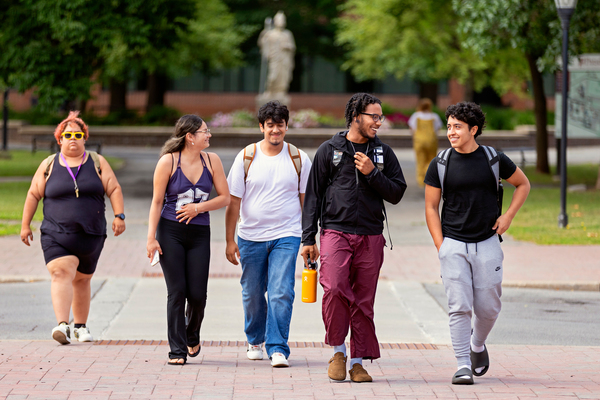 (Right to Left) Justin Hernandez '30, Jefferson De La Cruz '30, Joannes Avila '30 and Melanie Vargas '30 walk through Minerva Plaza on their way from one event to the next, during the EOP Summer Program at SUNY Potsdam.