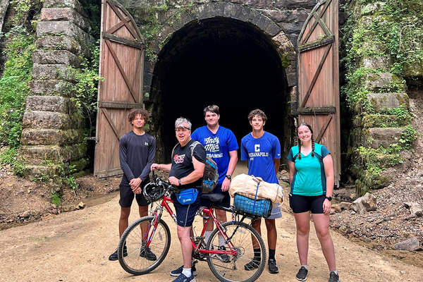 TRAILS AND TUNNELS: Faculty member James Godde (on bike) is pictured with the four students he led on a tour of Wisconsin. From the left are Calvin Cotton, Grant Haste, Lennon Klinck and Lexi Serpette.
