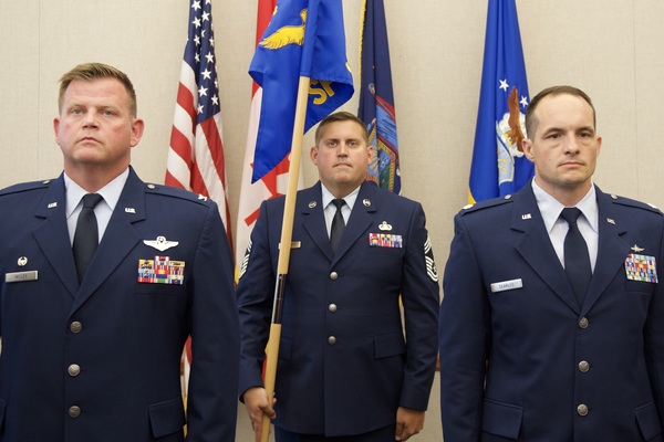 New York Air National Guard Col. Joseph Miller, 224th Air Defense Group commander, and Lt. Col. Jacob Searles stand at attention during the 224th Support Squadron assumption of command ceremony held at the Eastern Air Defense Sector on August 21, 2026. Miller presided over the ceremony, welcoming Searles as the squadron’s new commander. (U.S. Air National Guard photo by Barbara Olney)