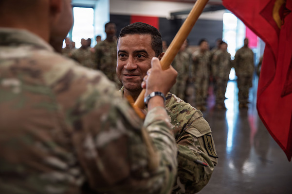 Capt. Rodrick Ortiz, incoming commander of of Charlie Battery, 1st Battalion, 258th Field Artillery Regiment, New York Army National Guard, passes the unit guidon 1st Sgt. Robert Delgado, during a ceremony at Jamaica Armory, New York, N.Y., Aug. 8, 2026. Ortiz, a Bronx resident,  assumed command from Capt. Christopher Guzzetta during the ceremony. (U.S. Army National Guard Photo by Spc. Stuart Martin)