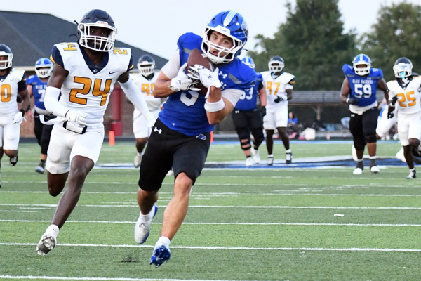 Lindsey Wilson University sophomore wide receiver Max Gainey of Louisville, Kentucky, hauls in 37-yard touchdown pass from junior quarterback Tate Rice of Manchester, Kentucky, to give the Blue Raiders a 37-0 lead over visiting Reinhardt (Georgia) University late in the second quarter of Thursday night’s game at Parnell Family Stadium. The Blue Raiders, ranked No. 6 in the NAIA, opened the 2026 season with a 52-24 win over the No. 23 Eagles. Gainey caught five passes for a game-high 158 total yards, including three for touchdowns.
