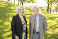Two SUNY Canton college council chairs stand next to one another on the college's campus.