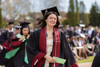 Jocelyn Shatraw walks toward the stage at Commencement at SUNY Potsdam.