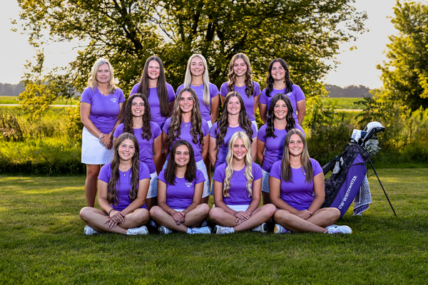 A group of college golfers posed together for a team photo.