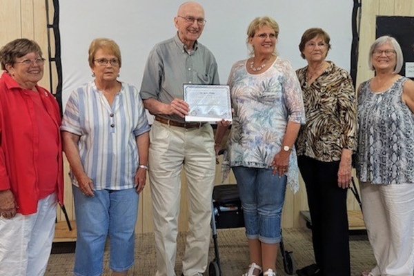 Photo L-R GFWC members make Jerry Pfabe a "History Hero!" Bonnie Kruse, Jeane Loos, Pfabe, Lucinda Johnson, Marilyn Kaliff and Ellen Chafgin