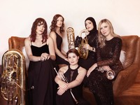 Seraph Brass poses with their instruments. They are all wearing formal black attire.
