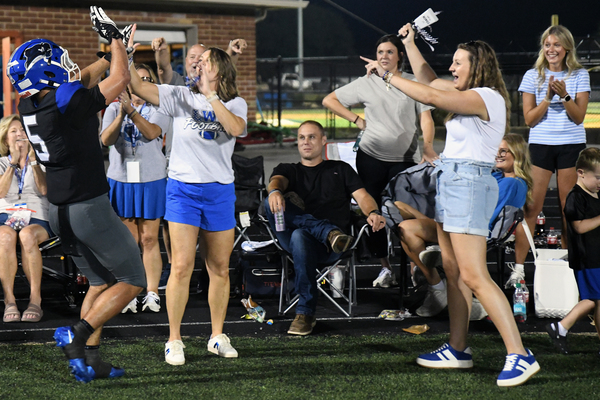Lindsey Wilson University sophomore wide receiver Max Gainey of Louisville, Kentucky, celebrates with Blue Raider fans in the East end zone of Parnell Family Stadium after scoring a touchdown on a 37-yard pass play from junior quarterback Tate Rice of Manchester, Kentucky, in third quarter of Saturday night’s game against Ave Maria (Florida) University. The touchdown made the score 44-3 as the Blue Raiders coasted to a 52-6 win. For the game, Rice threw three touchdowns, all to Gainey. With 10:11 remaining in the fourth quarter, the game was called due to lightning in the area.
