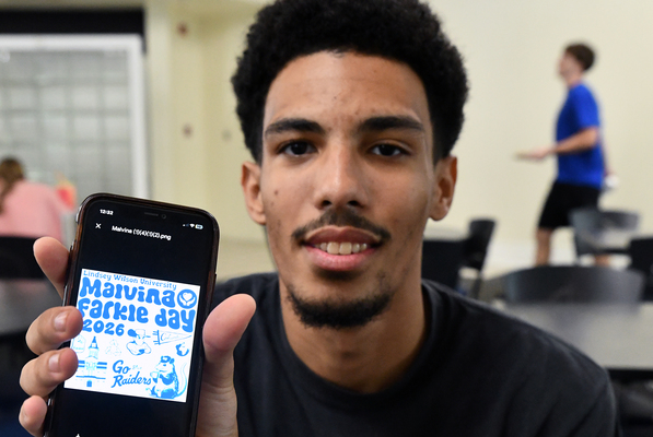 Lindsey Wilson University student Bishop Bale-Waters ’28 of Shelbyville, Kentucky, displays the winning design he created for this year’s Malvina Farkle Day T-shirt. The annual fall event celebrates a day of community service at the university.